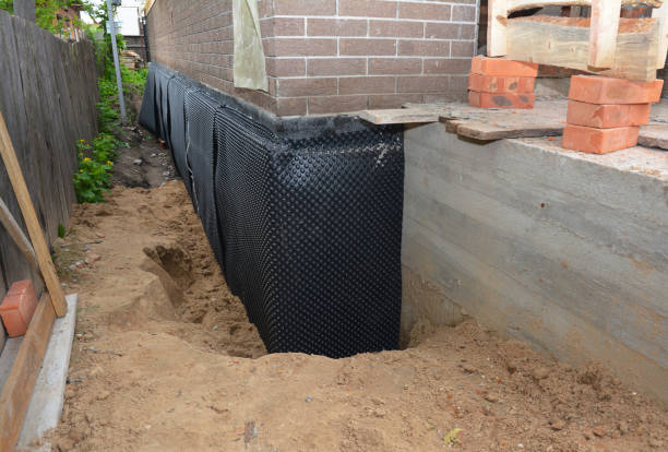 Happy homeowners after waterproofing job in Mason
